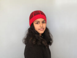 a red beanie with black dash pattern